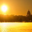 Bright sun reflected in steamy lake surface