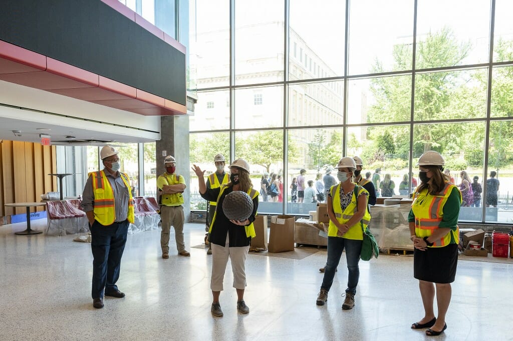 Missy Nergard, director of the UW Office of Sustainability, shows a sample of a plastic spacer ball that was used to reduce the amount of concrete used in the construction of the Chemistry Building addition.