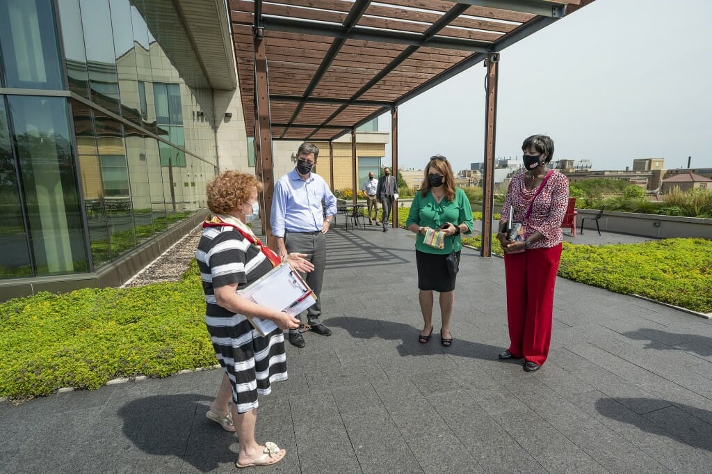 Linda Zwicker, senior assistant dean of communications and advancement in the School of Human Ecology, gives a tour of Nancy Nicholas Hall. From left are Zwicker, DOA Secretary Joel Brennan, DFI Secretary Kathy Blumenfeld and DSPS Secretary Dawn Crim.