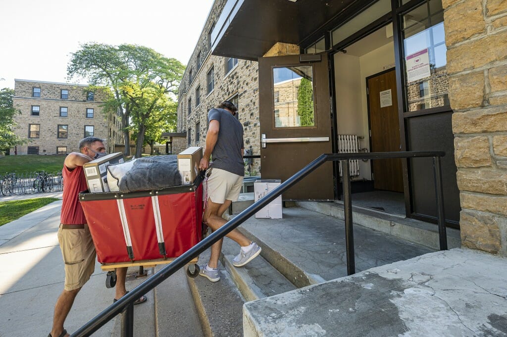 Chuck Steffen and his parents Danna and Terry navigate the stairs with the moving trolley.