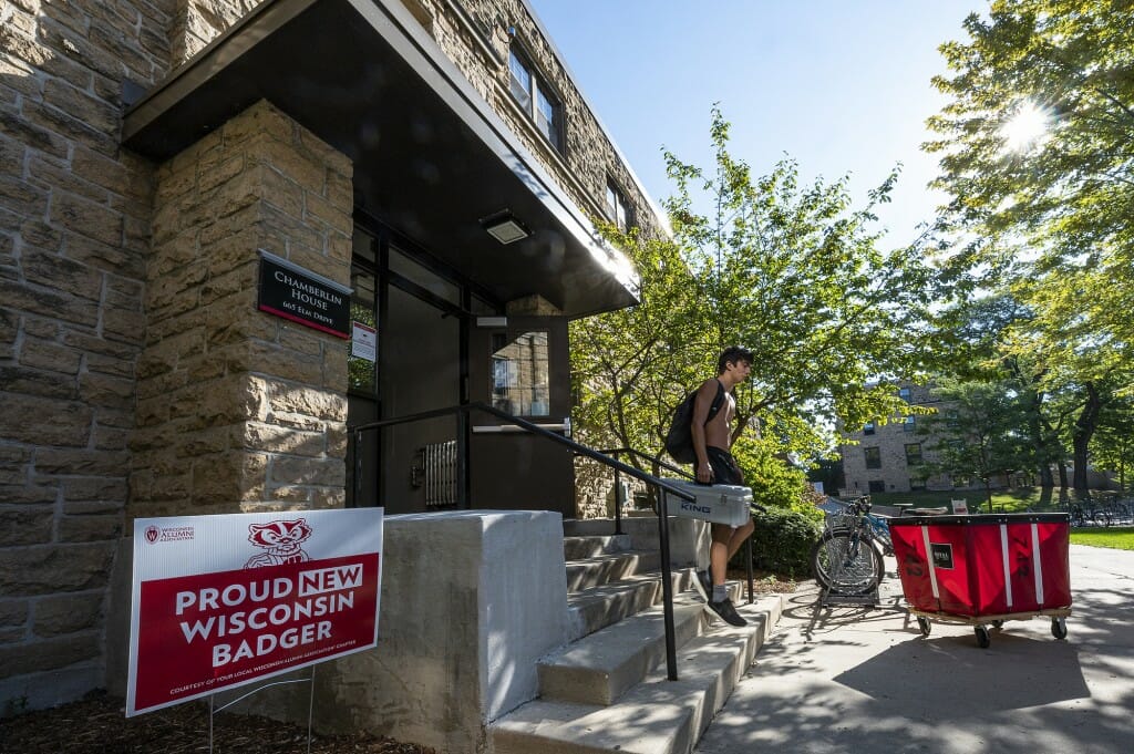 New student William Arnold walks out of Chamberlin House in Kronshage Residence Hall after getting his items settled.