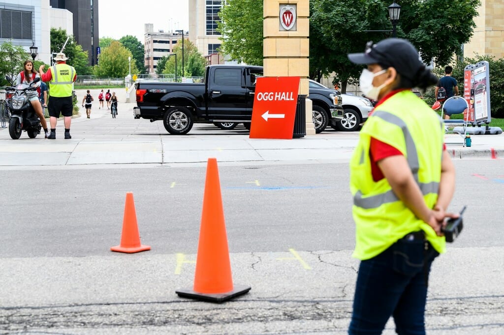 Staff members guide traffic as first-year students move into Sellery Residence Hall.