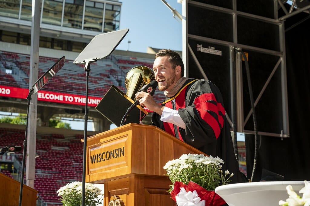 Man at podium holding trophy