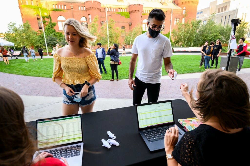 Graduates standing at a table