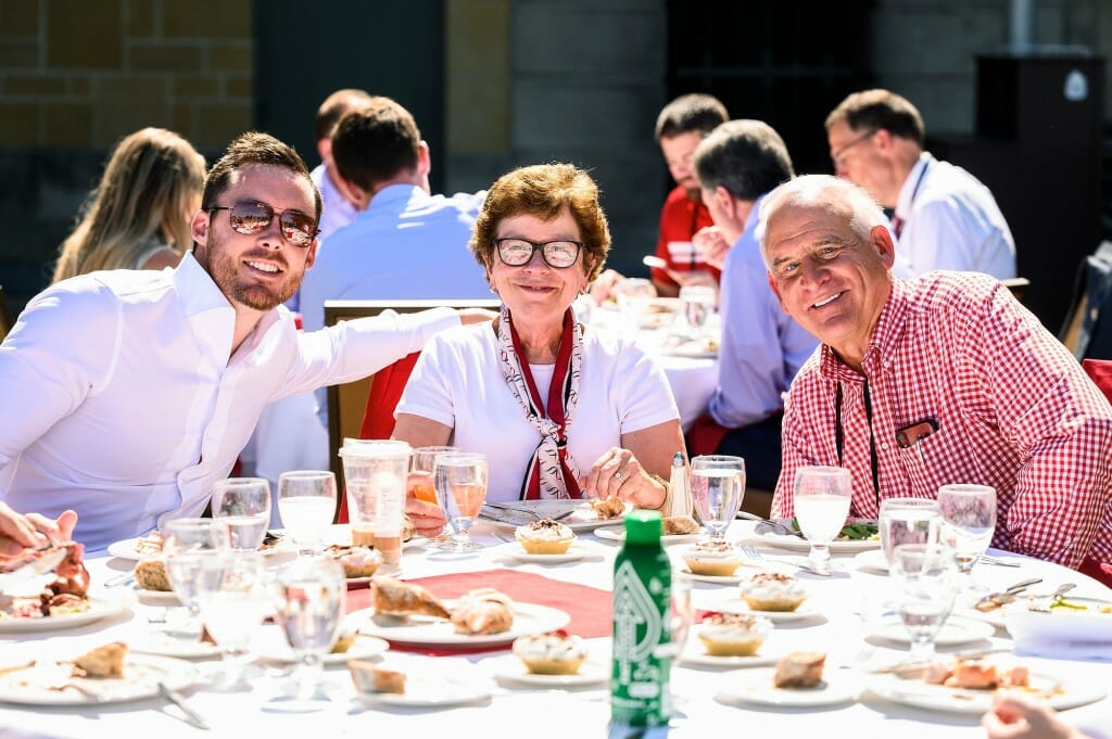 People sitting at a table with lunch dishes