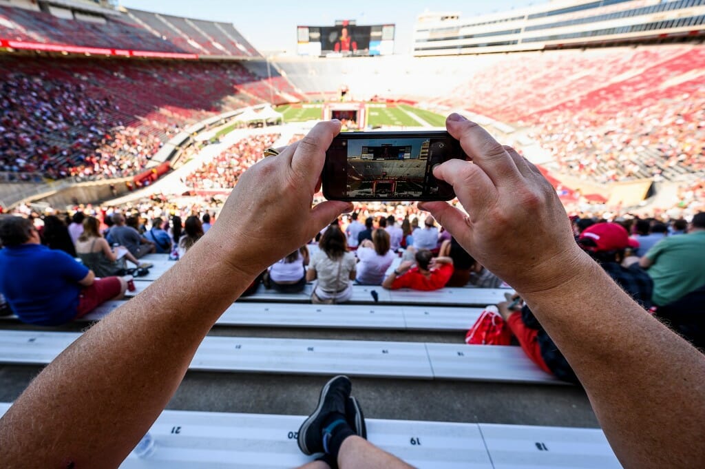 Person taking phone picture of stadium