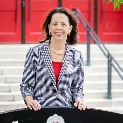 Hess standing at entrance to Education Building