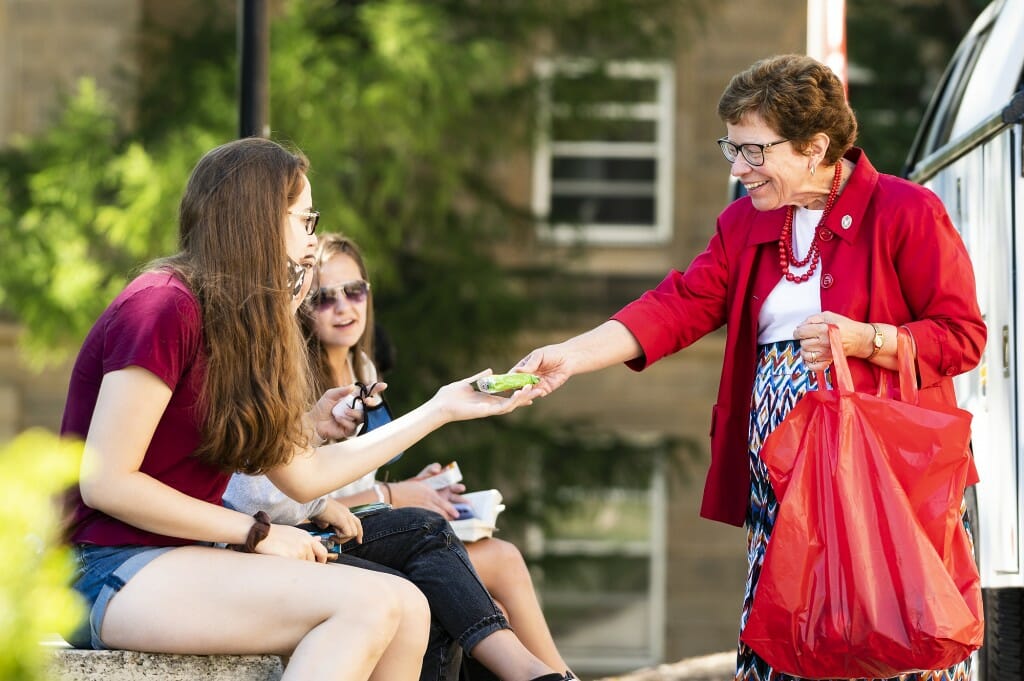 Chancellor Rebecca Blank hands out snacks to students waiting for class in front of Bascom Hall during the first morning of classes.