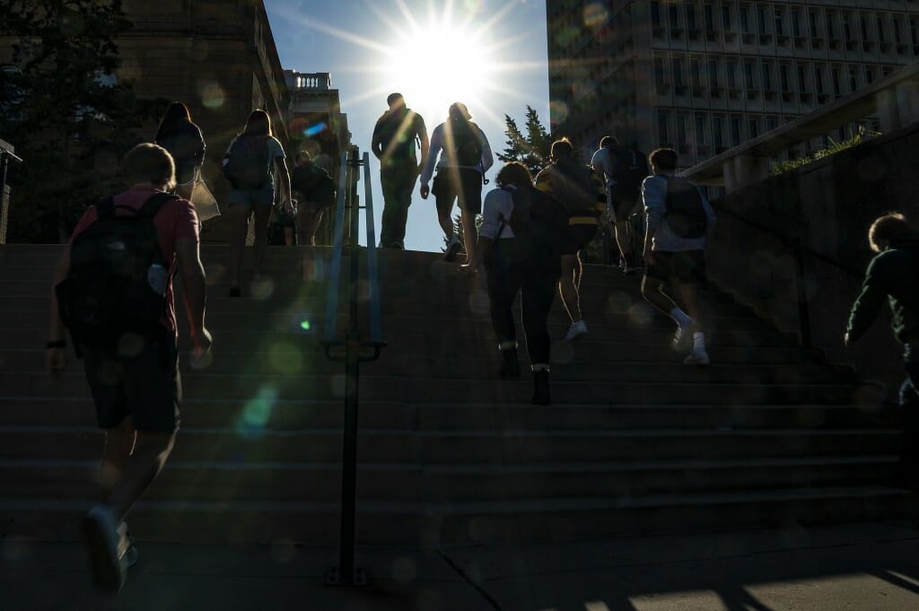 Students walk up the steps between Ingraham Hall and Van Vleck Hall during the first morning of classes for the fall semester.