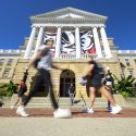 Students and pedestrians walk in front of Bascom Hall during the first morning of classes for the Fall semester on Sept. 8, 2021. A campus health mandate requires people to wear face mask indoors – except while eating or drinking – as the coronavirus (COVID-19) pandemic continues. Face coverings are not required while outdoors. (Photo by Bryce Richter / UW-Madison)