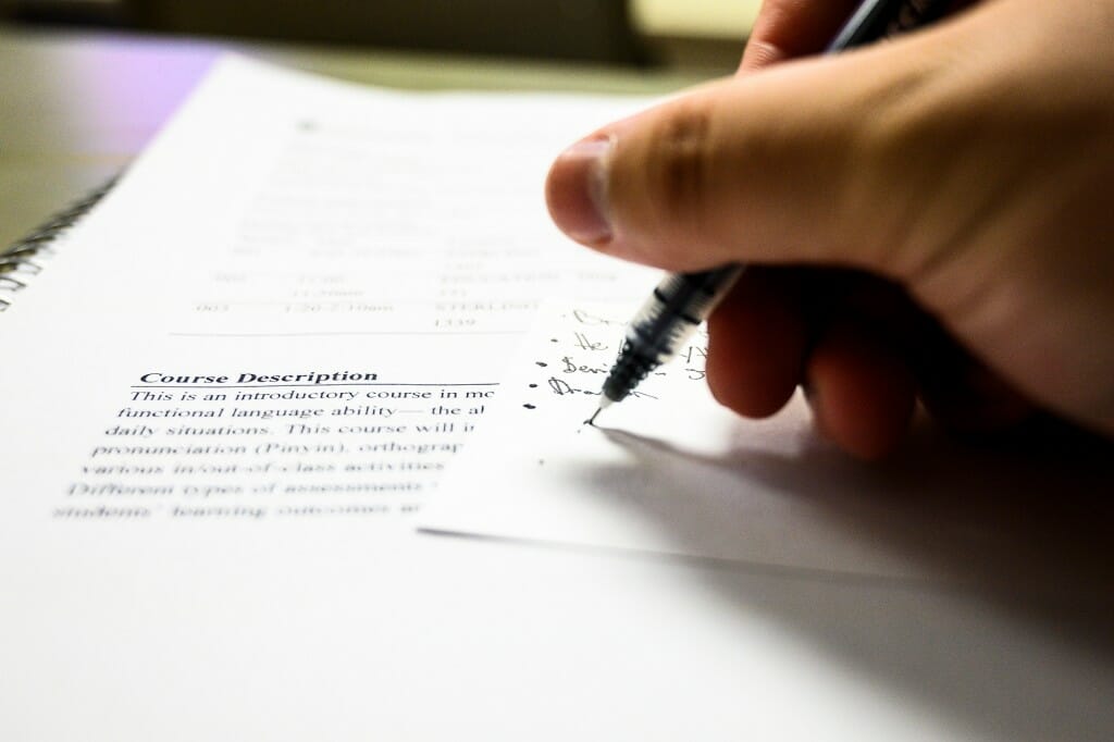 A student takes notes during a Chinese language class taught by Tianlu Zhang, an assistant faculty associate, in Sterling Hall.