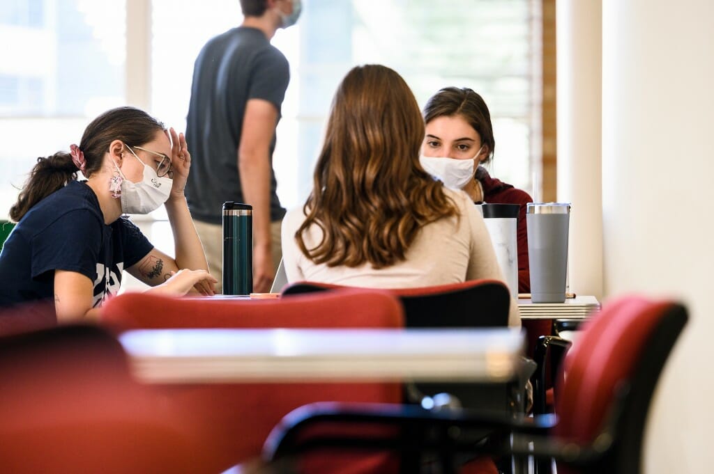 From left to right, Claudia Epland, Rachel Hawley (back to camera) and Makaila Wallin, all third-year doctoral students in the School of Pharmacy, study in a common area of Rennebohm Hall.