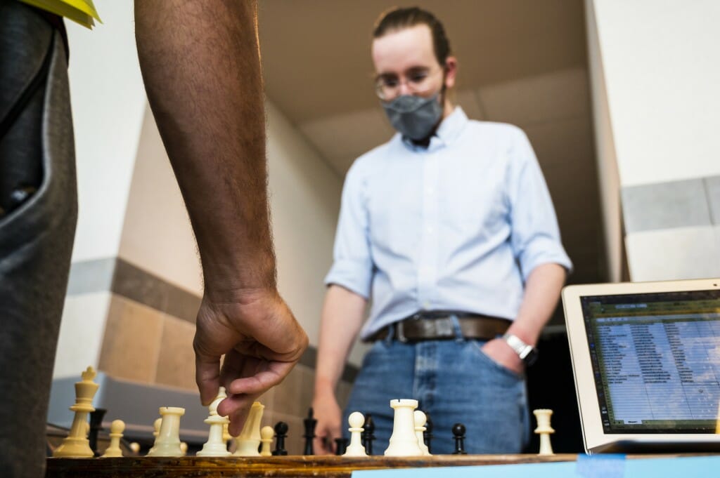 Jeff Covington, a graduate student, plays chess with prospective Chess Club members.