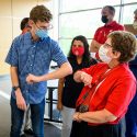 Microbiologist Jaret Schroeder uses an elbow bump to greet Chancellor Blank.