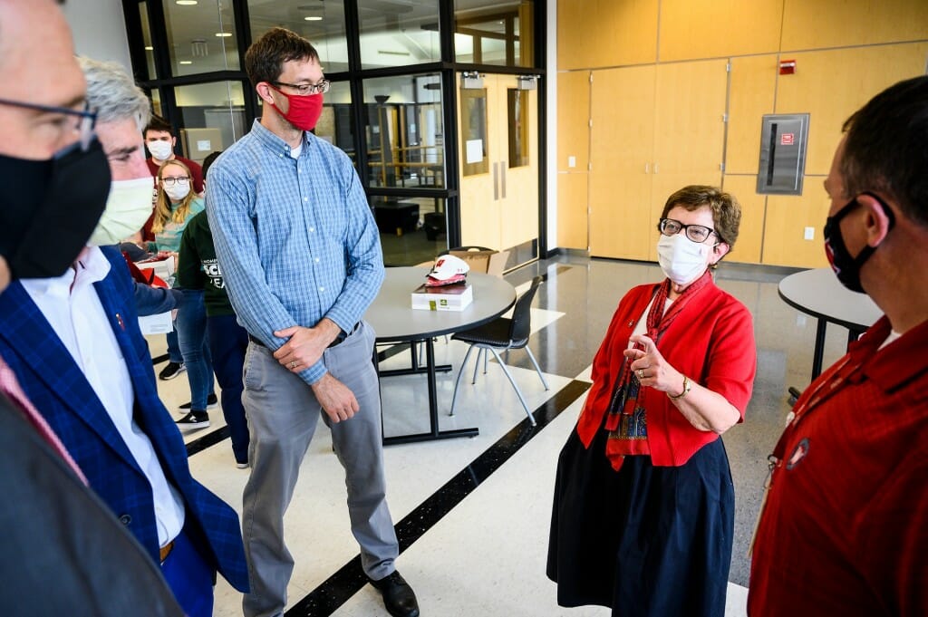 Chancellor Blank praises the lab's efforts as Allen Bateman, director of the Communicable Disease Division at the Wisconsin Laboratory of State Hygiene, listens.