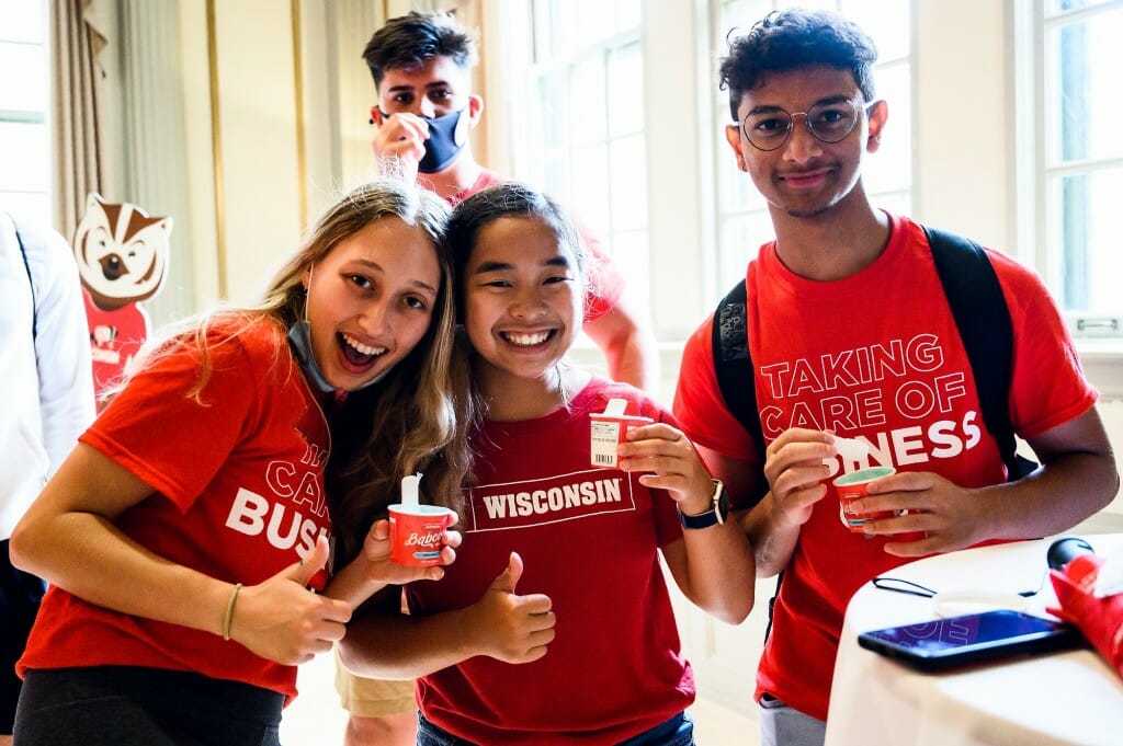 From left to right, first-year students Hannah Kimmel, Kendyl Johnson and Nirhankar Shylakumar enjoy cups of Babcock ice cream during a New Student Ice Cream Welcome event held in Great Hall in the Memorial Union on Sept. 3.