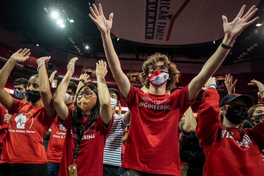 Students with arms raised