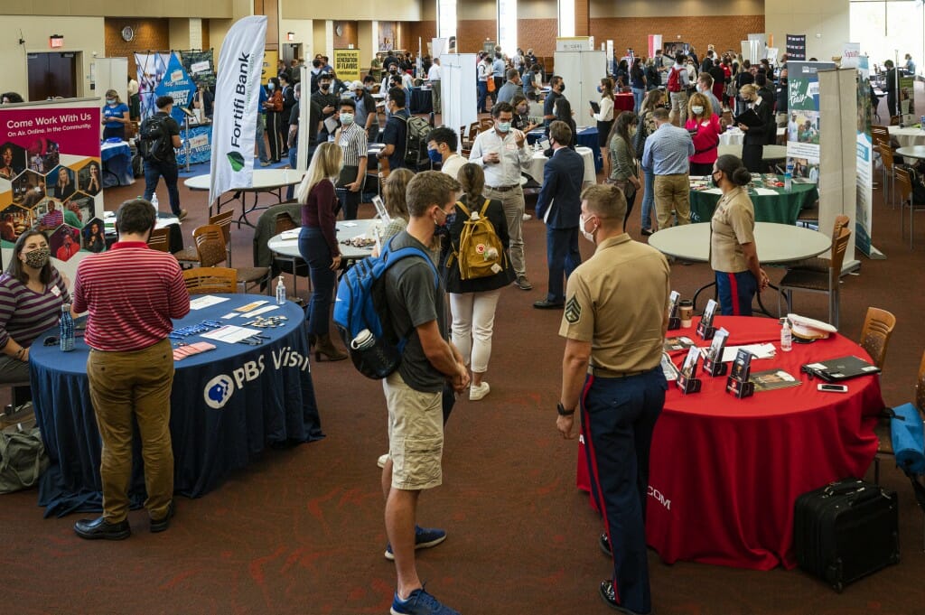 Students talk with a recruiters and prospective employers at their information booths during the fall Career and Internship Fair.