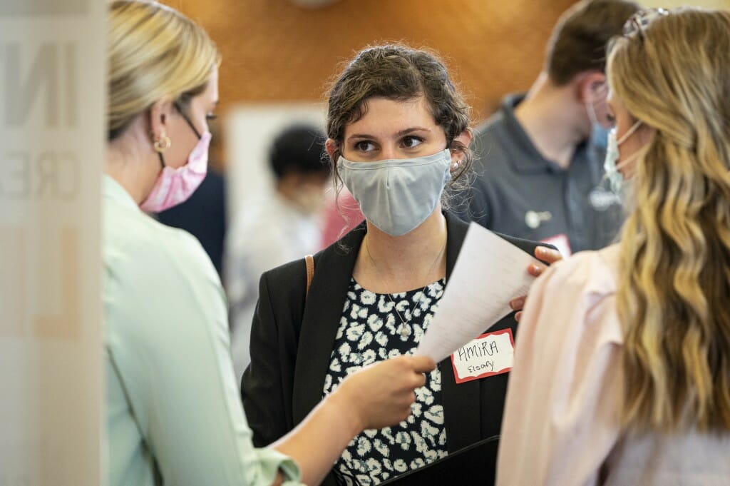 Student Amira Elsafy (center) talks with a recruiter.