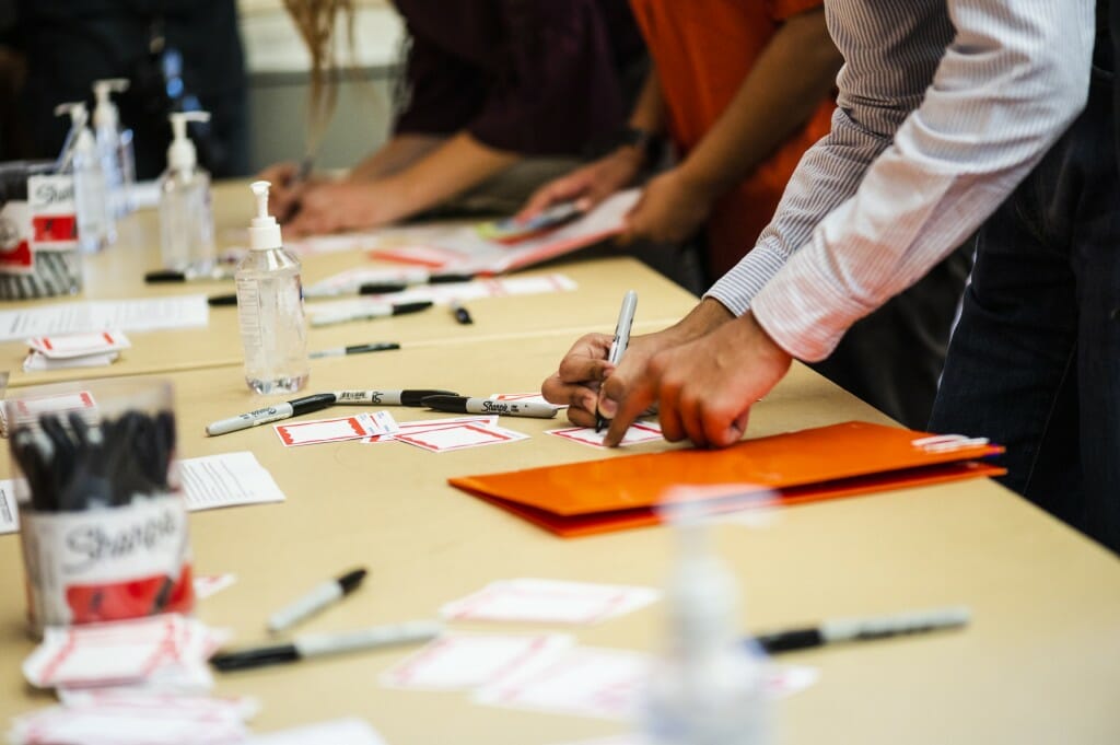 Students fill out name tags before meeting with recruiters.