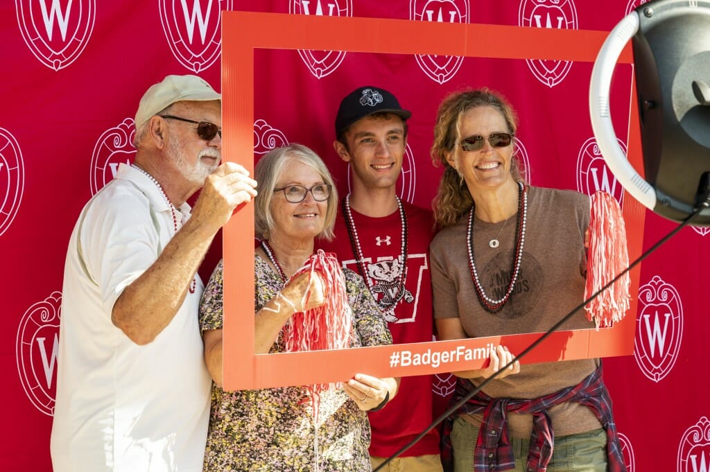 Jack Meyer, along with his mother and grandparents, smile for the camera in a photo booth outside Union South.