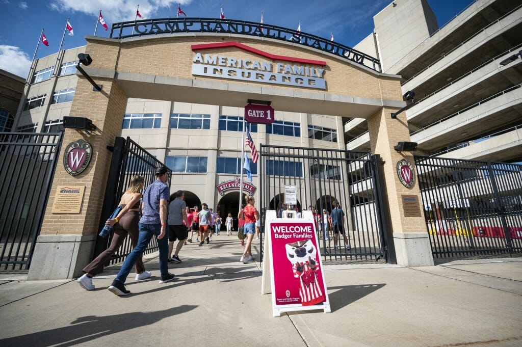 Families enter Camp Randall Stadium for a chance to walk out on the playing field and take photos.