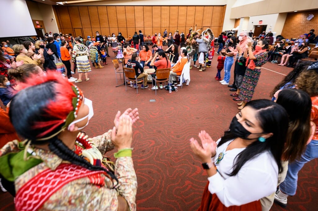 Dancers applaud at the end of a community dance.