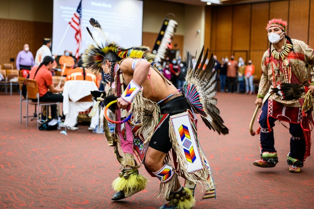 At center, dancer Josh Zunker of Ho-Chunk Nation performs with  those from several other tribes.