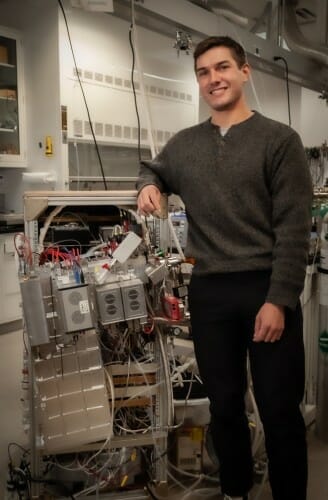 Novak standing next to equipment