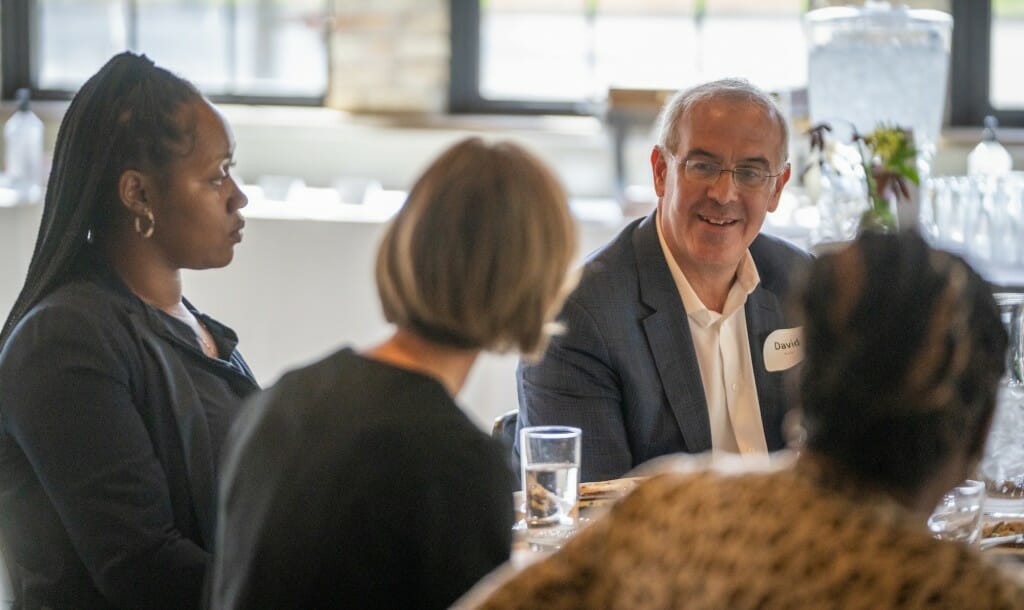 Brooks speaks with Cartecia Lawrence, left, and Susan Webb Yackee, center, of the La Follette School of Public Affairs.