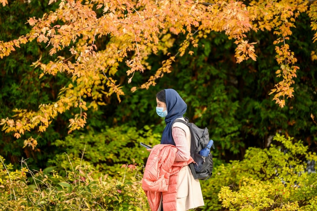 A warm coat and umbrella are at hand to provide protection from the elements in case this pleasant day near Union South turns blustery — as fall days in Wisconsin are wont to do.