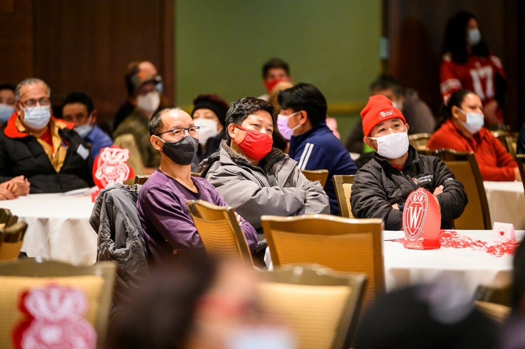 Audience members listen to a presentation.