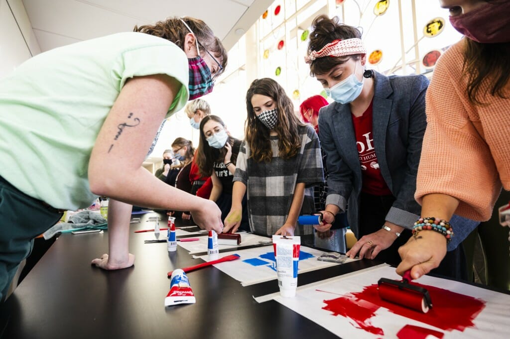 Nora Renick Rinehart, an MFA Candidate in Design Studies, guides students and community members as they participate.