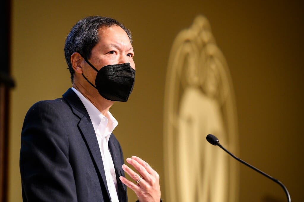 Jeung speaking at a podium