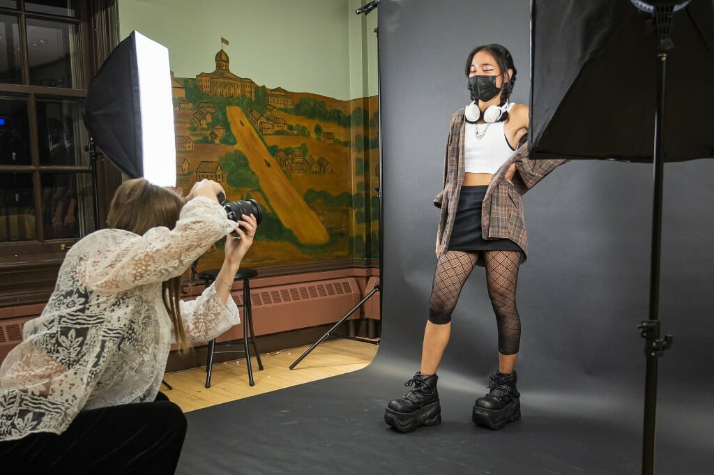 A photographer takes a photo of a woman.