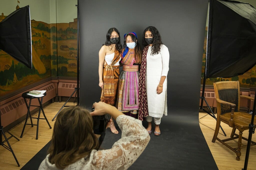 Three women pose together.