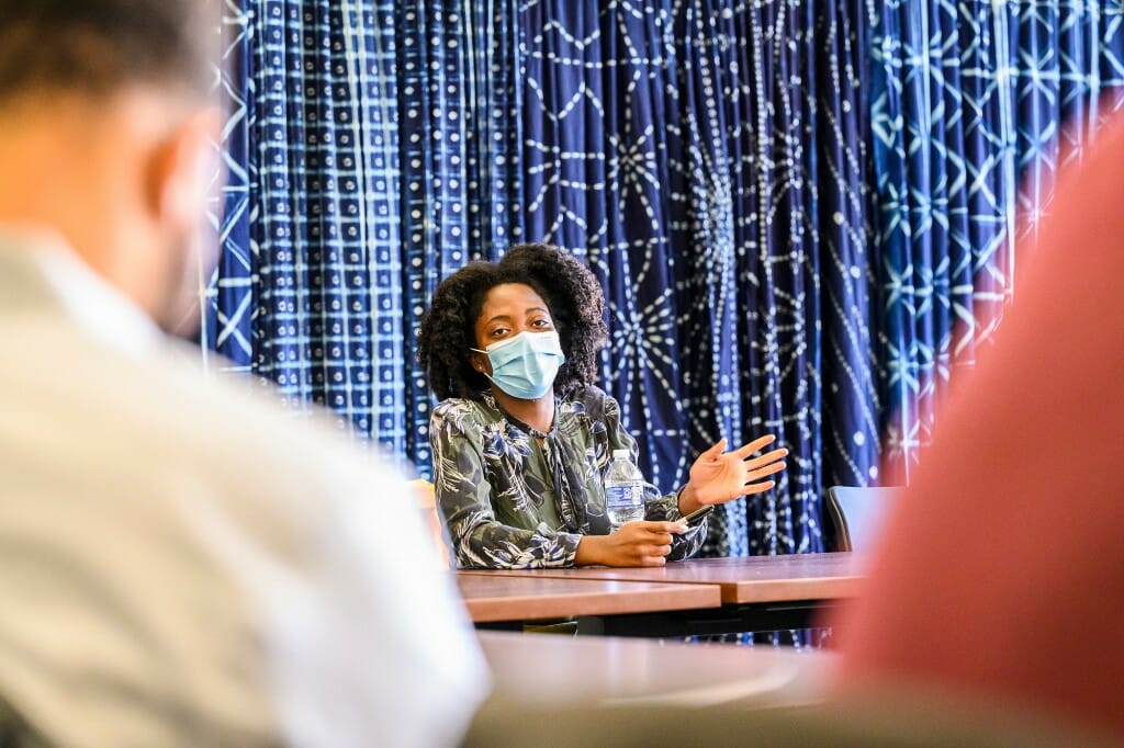 Gyasi speaking at a table