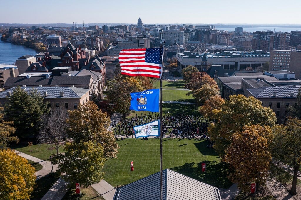 Flags flying with Capitol and Madison skyline in background