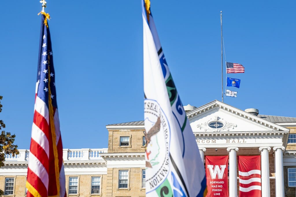 Flags partially up the pole