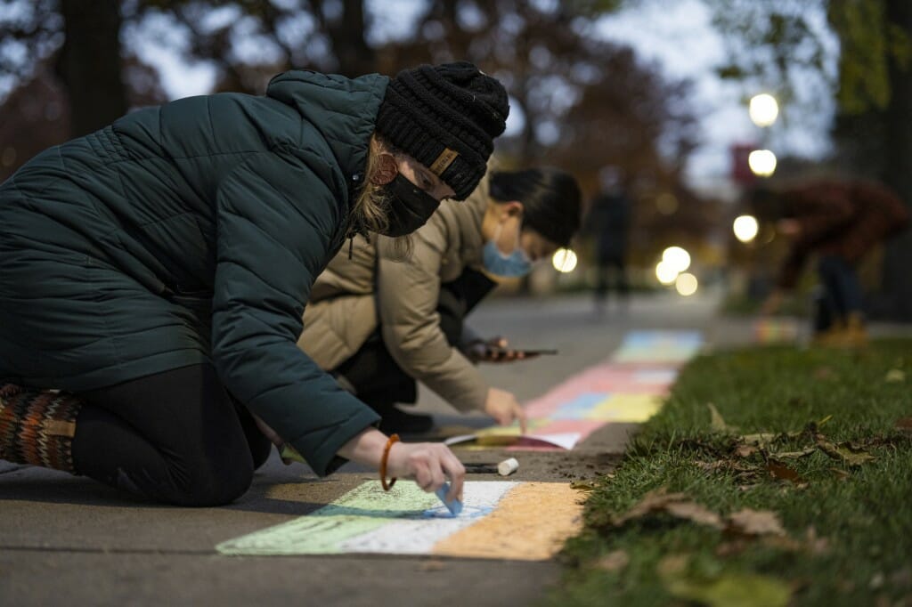 Kate McCleary, associate director of the Global Engagement Office in the School of Education, draws an international flag.