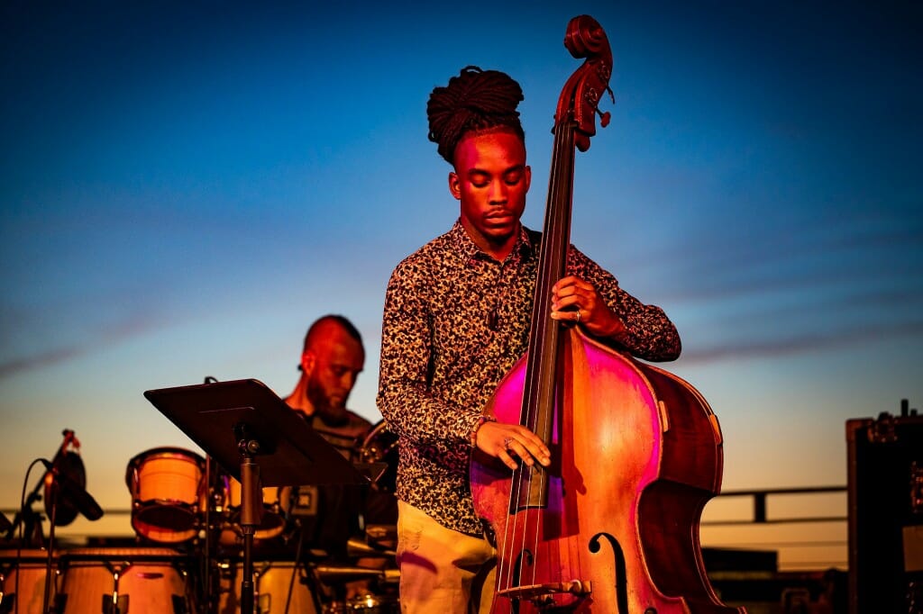 A person playing a string bass on the Memorial Union Terrace