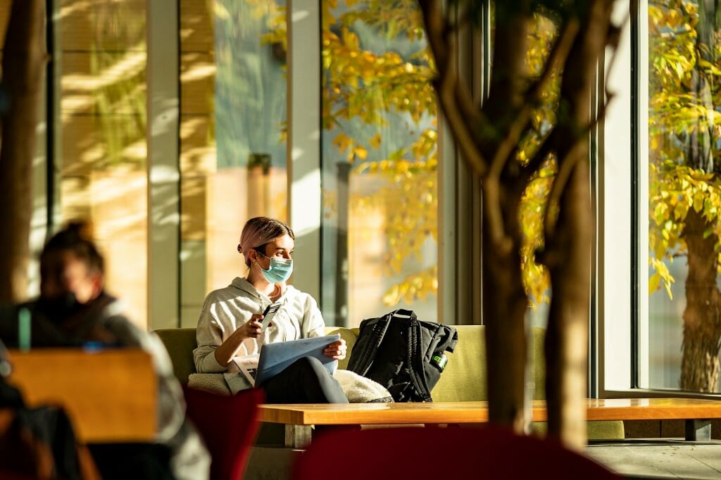 A person sitting in the atrium of the Discovery Building