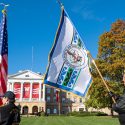 People carrying flags in front of Bascom Hall