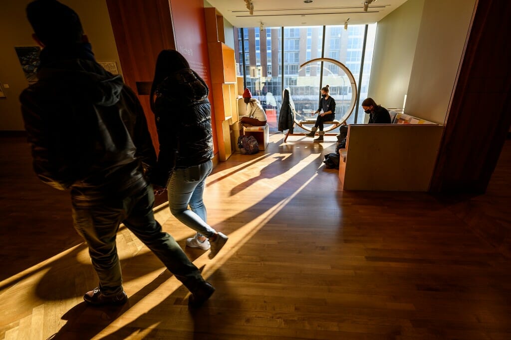 Students study in a sunny alcove.