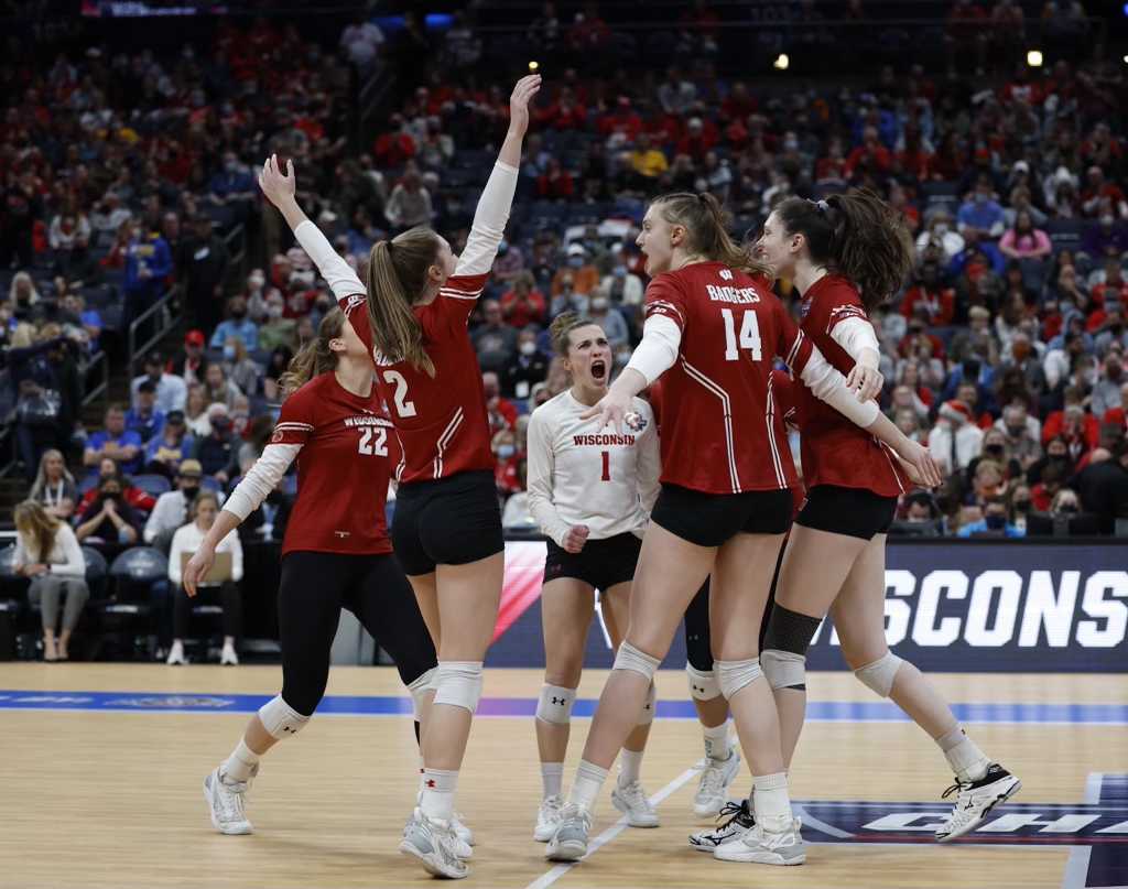 Libero Lauren Barnes (No. 1, in white) and the team celebrate.