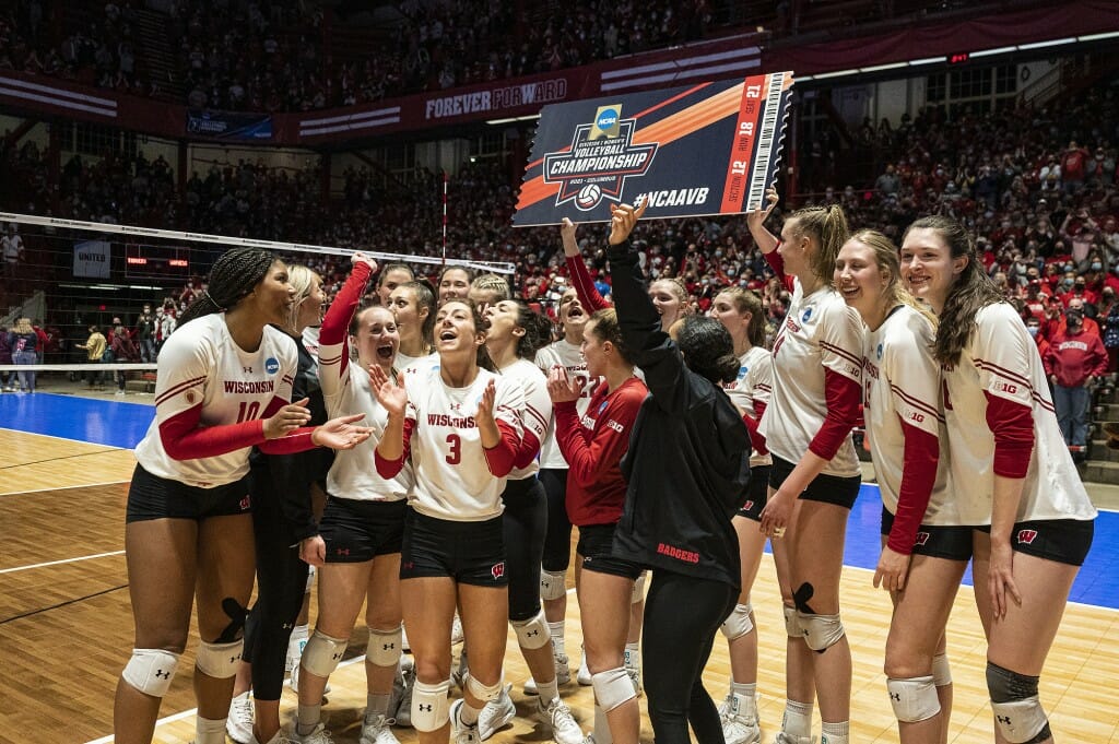 Members of the volleyball team celebrate the match win.