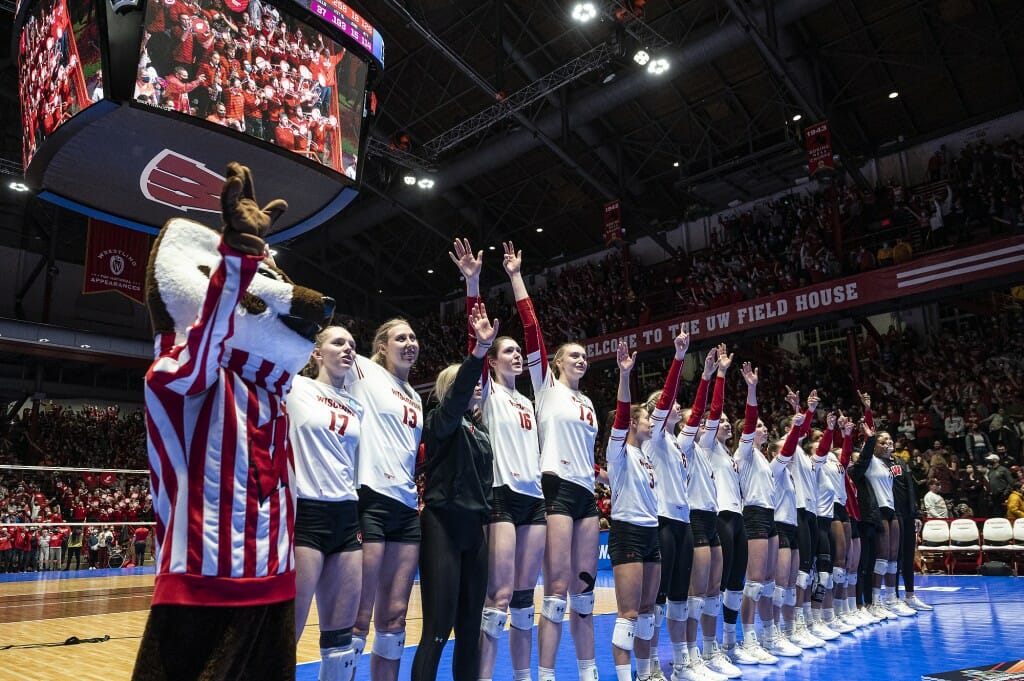 Members of the team and UW mascot Bucky Badger sing Varsity following the win.