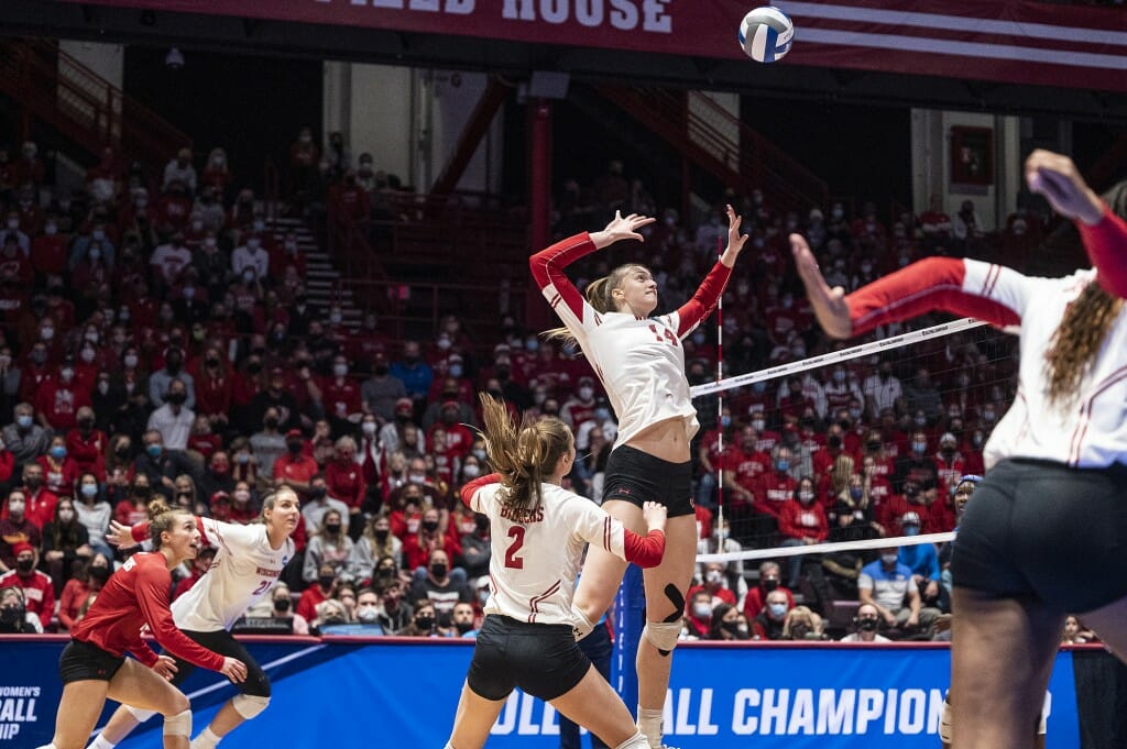 Smrek jumps at the net to reach the ball