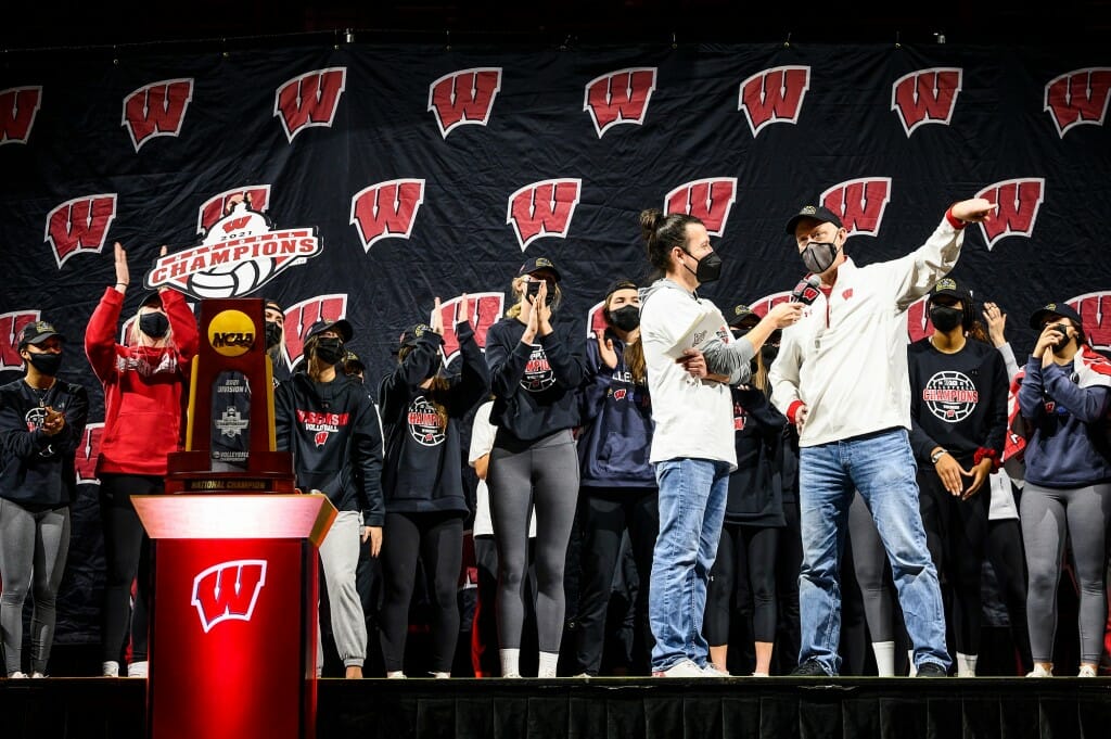 Arias conducting an interview on stage in front of players