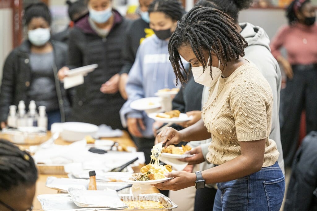 Attendees fill their plates with food during Soul Talk.